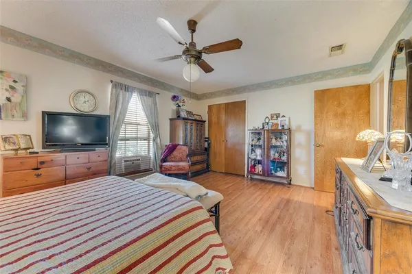 a bedroom with furniture and a flat screen tv