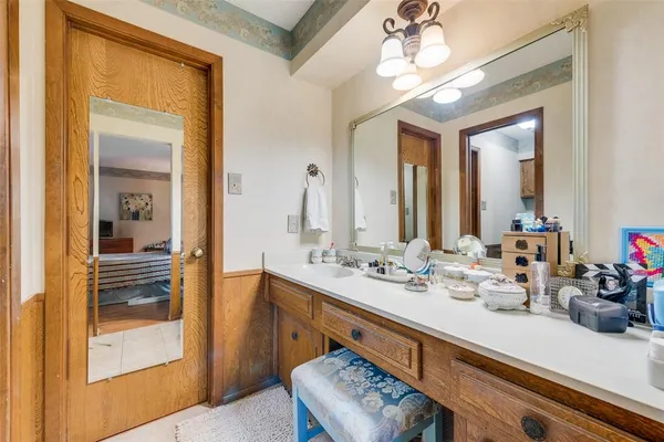 a bathroom with a sink a large mirror and a shower