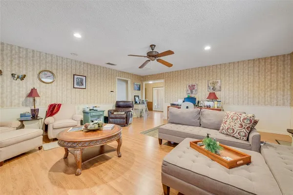 a spacious bedroom with a bed and a table in it