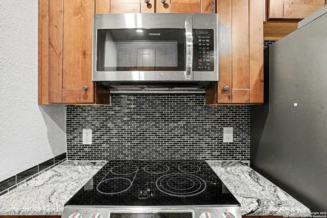 a bathroom with a stove and cabinets