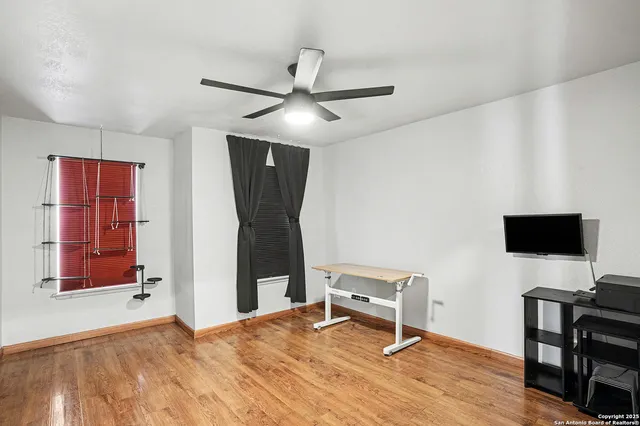 a view of a workspace with furniture and a window