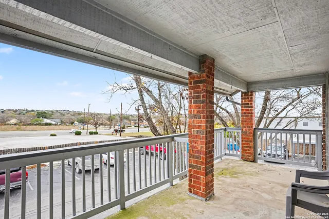 a view of a balcony next to a yard