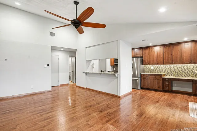 a view of a kitchen with a stove cabinets and wooden floor