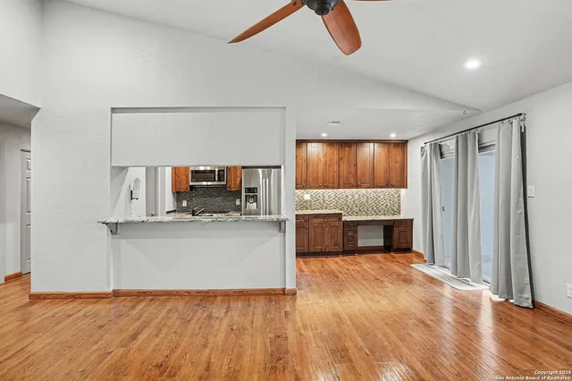 a living room with stainless steel appliances kitchen island granite countertop furniture and a kitchen view