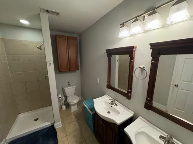 a bathroom with a toilet a sink and mirror