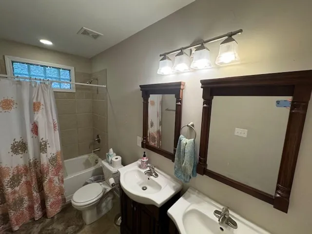 a bathroom with a sink toilet and shower