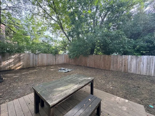 a view of a backyard with wooden fence