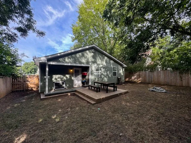 a view of a house with backyard and sitting area