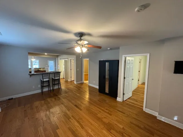 a view of a livingroom with furniture wooden floor and window