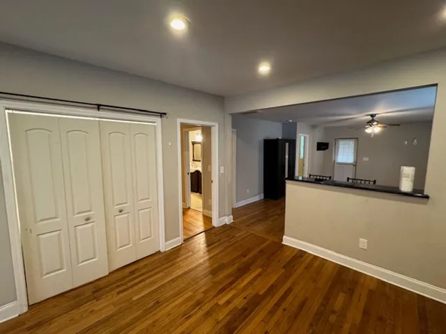 a view of a room with wooden floor and a window