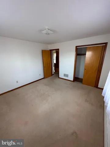 a kitchen with a sink a stove a window and cabinets