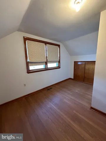 an empty room with wooden floor