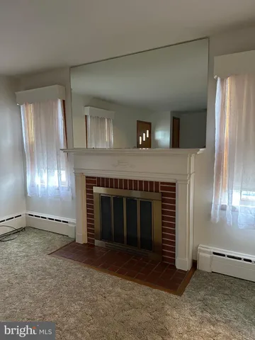 a view of an empty room with a fireplace
