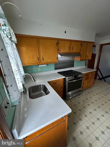 a stove top oven sitting inside of a kitchen