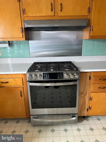 a kitchen with granite countertop a refrigerator and a stove