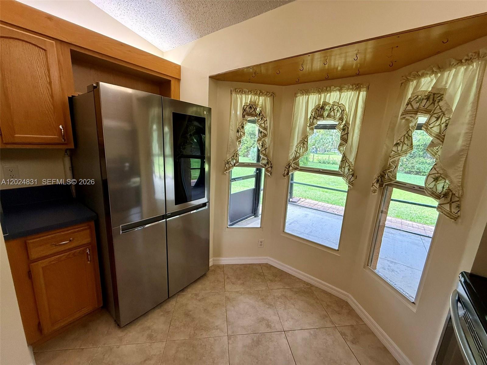 15819 76th Road North Loxahatchee, FL 33470 - Photo 16 of 45 a kitchen with stainless steel appliances granite countertop a refrigerator and a sink