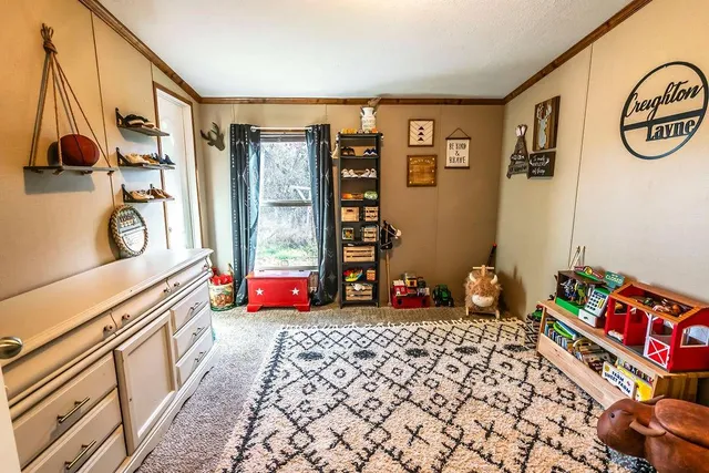 a bedroom with furniture and a large window