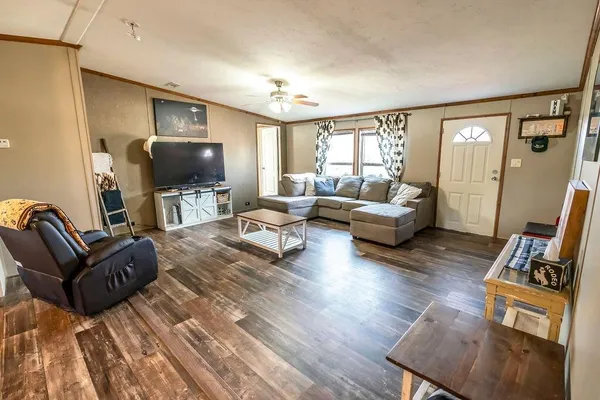 a living room with furniture and a flat screen tv