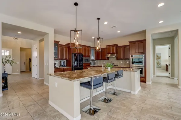 a view of a dining room with furniture wooden floor and chandelier