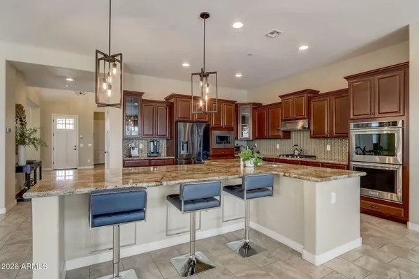 a room with a potted plant on a counter and a wooden floor