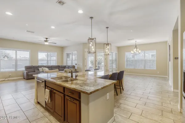 a bedroom with a bed a chandelier and a window