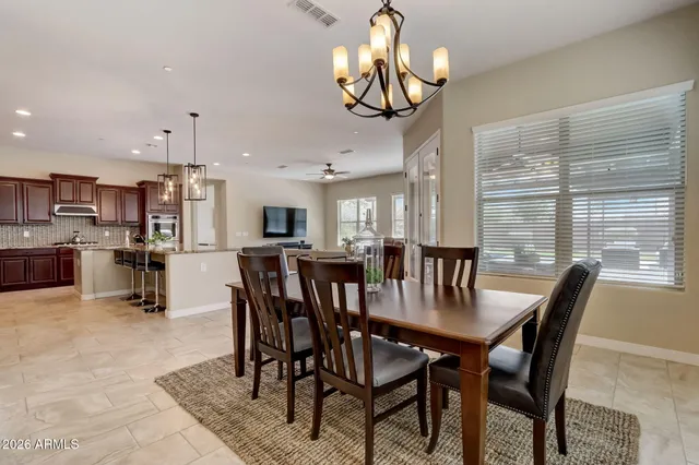 a spacious bedroom with a bed and wooden floor
