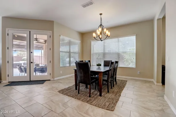 a large kitchen with a large island in the center a sink stainless steel appliances and a center island