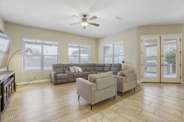 a living room with furniture a flat screen tv and a window