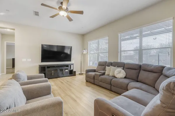 a living room with furniture and a wooden floor