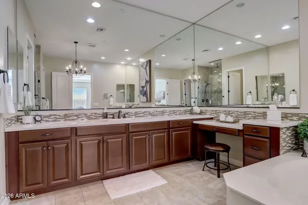 an empty room with chandelier fan and windows