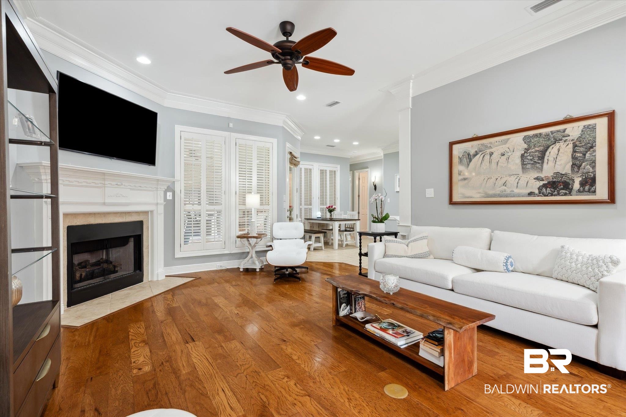 804 Country Club Road Mobile, AL 36609 - Photo 7 of 63 Living room with a tiled fireplace, ornamental molding, ceiling fan, and hardwood / wood-style floors