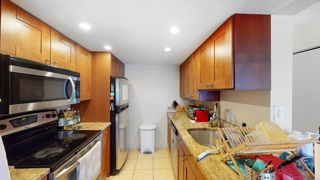 108 Peterborough Street, Unit 3E Boston, MA 02215 - Photo 9 of 11 a kitchen with stainless steel appliances granite countertop a sink stove and cabinets