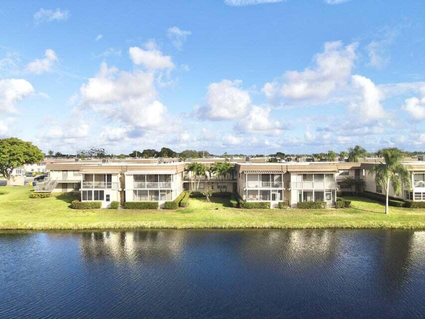 a view of residential houses with swimming pool and lake view