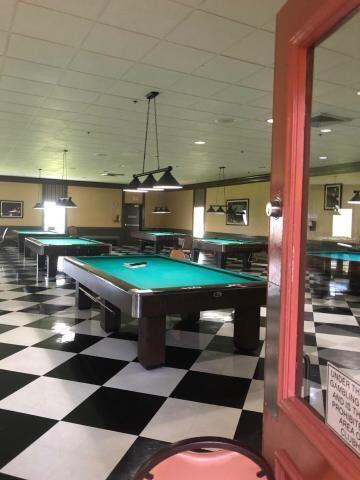 283 Saxony Circle, Unit 283 Delray Beach, FL 33446 - Photo 13 of 19 a room with pool table and wooden floor