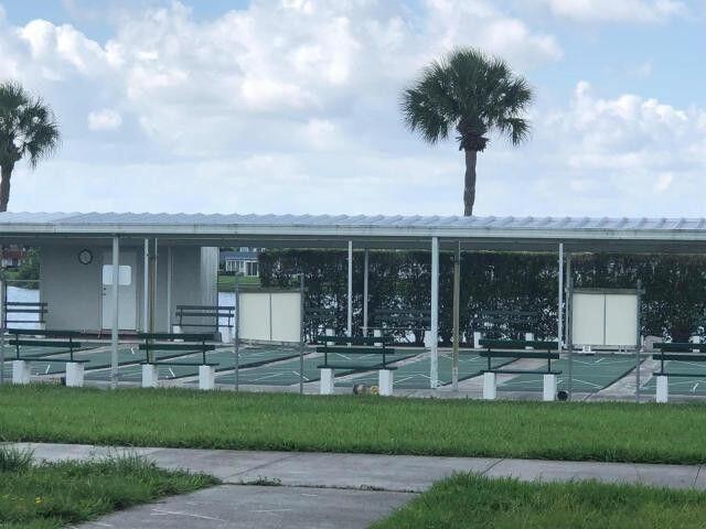 283 Saxony Circle, Unit 283 Delray Beach, FL 33446 - Photo 19 of 19 a front view of a house with porch and garden