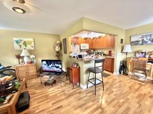 283 Saxony Circle, Unit 283 Delray Beach, FL 33446 - Photo 2 of 19 a living room with fireplace furniture and a floor to ceiling window