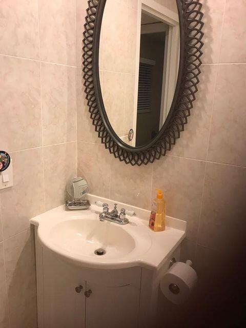 283 Saxony Circle, Unit 283 Delray Beach, FL 33446 - Photo 5 of 19 a bathroom with a sink mirror and vanity