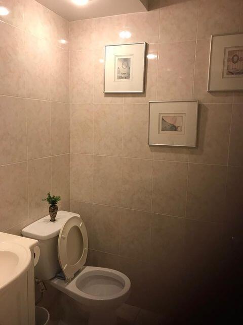 283 Saxony Circle, Unit 283 Delray Beach, FL 33446 - Photo 6 of 19 a bathroom with a toilet a sink and mirror