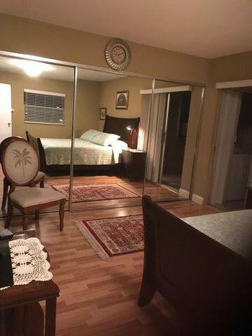 283 Saxony Circle, Unit 283 Delray Beach, FL 33446 - Photo 8 of 19 a bedroom with furniture and a window