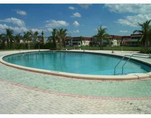 283 Saxony Circle, Unit 283 Delray Beach, FL 33446 - Photo 10 of 19 a view of a swimming pool and a yard