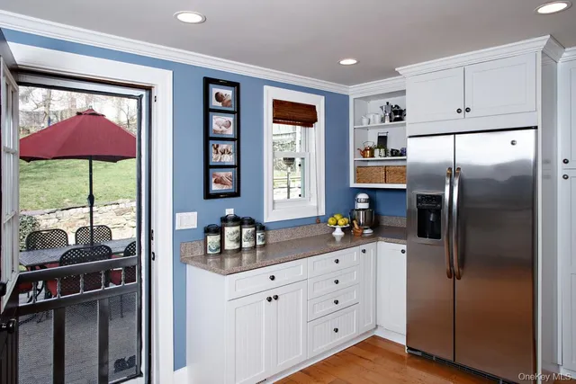 a kitchen with a refrigerator and cabinets