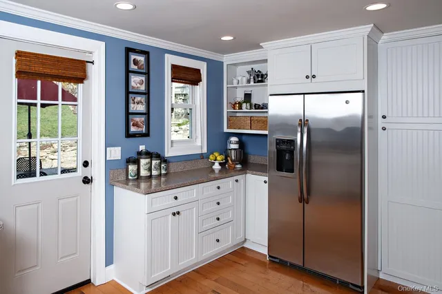 a kitchen with stainless steel appliances a refrigerator sink and cabinets
