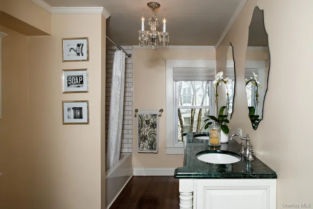 a bathroom with double vanity sinks and a mirror