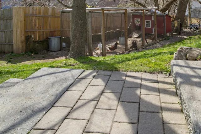 a view of a patio with table and chairs under an umbrella