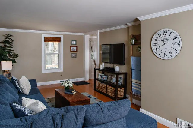 a living room with furniture a window and a flat screen tv