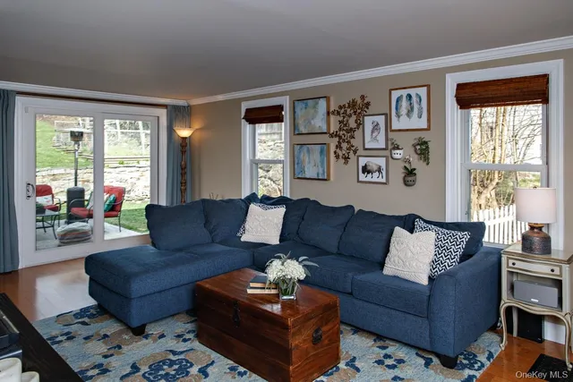 a living room with furniture and large windows