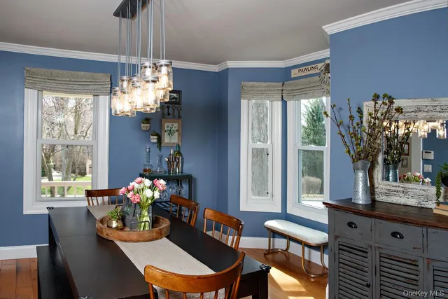 a dining room with furniture a chandelier and window