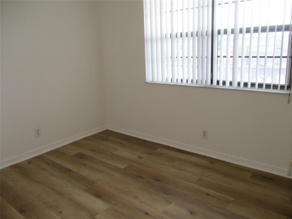 9233 Southwest 8th Street, Unit 311 Boca Raton, FL 33428 - Photo 11 of 19 an empty room with wooden floor