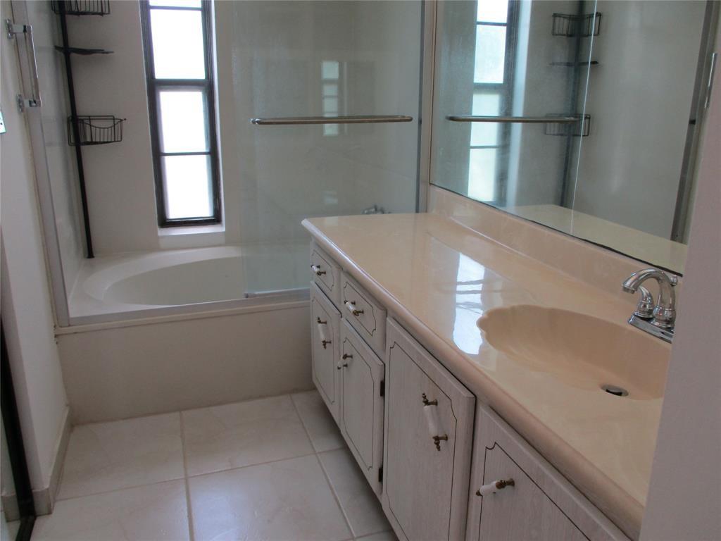 9233 Southwest 8th Street, Unit 311 Boca Raton, FL 33428 - Photo 12 of 19 a bathroom with a sink and a large mirror