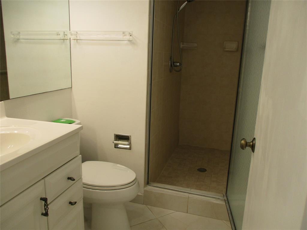 9233 Southwest 8th Street, Unit 311 Boca Raton, FL 33428 - Photo 15 of 19 a bathroom with a toilet and a shower
